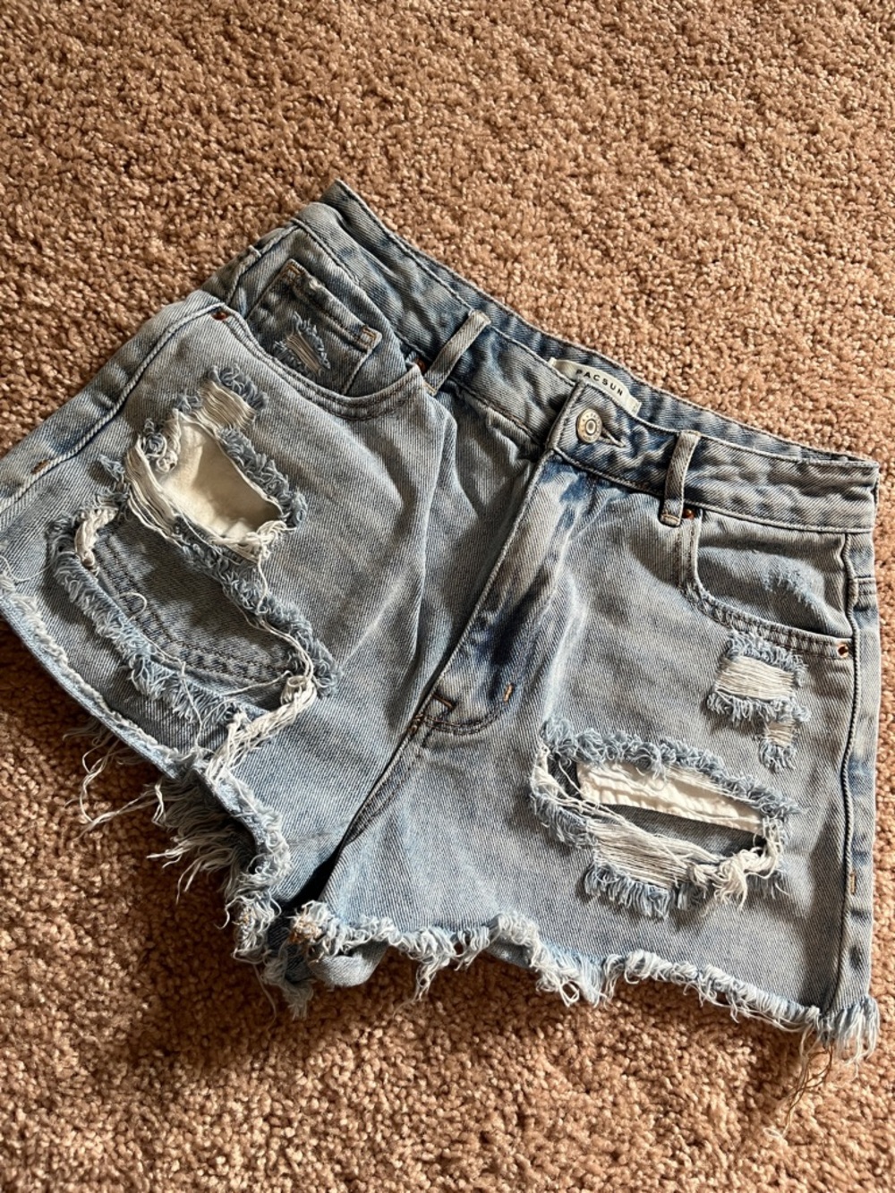 light wash blue jean distressed shorts